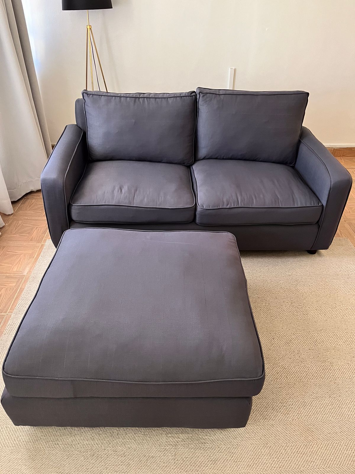 Selling a comfortable gray 2 seater plus ottoman. Used for 1 year and very well taken care of. Selli